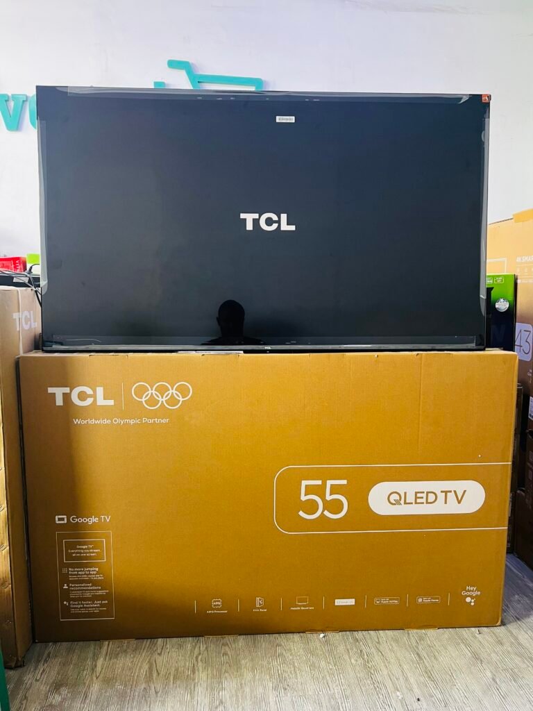 1 – TCL East Africa Kenya TCL 55-inch QLED TV box on a brown packing carton in a store setting, brand logo visible on the screen and box edge